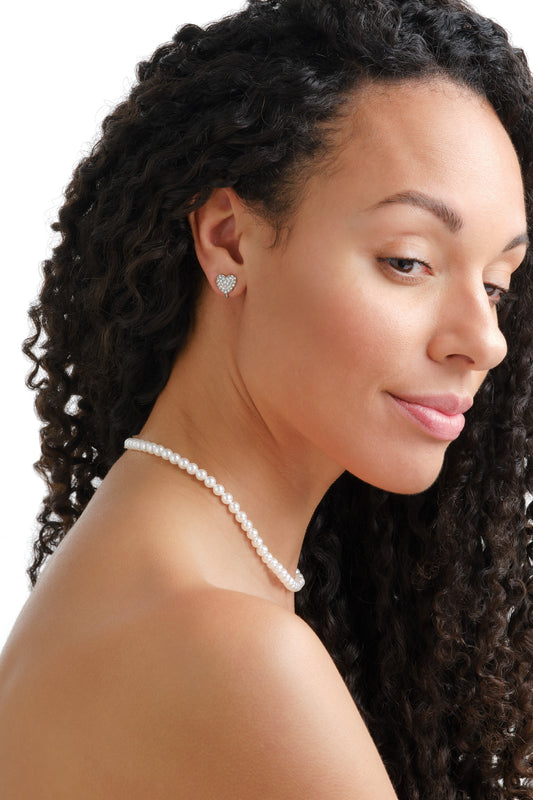 A model wearing platinum crystal heart clip on earrings