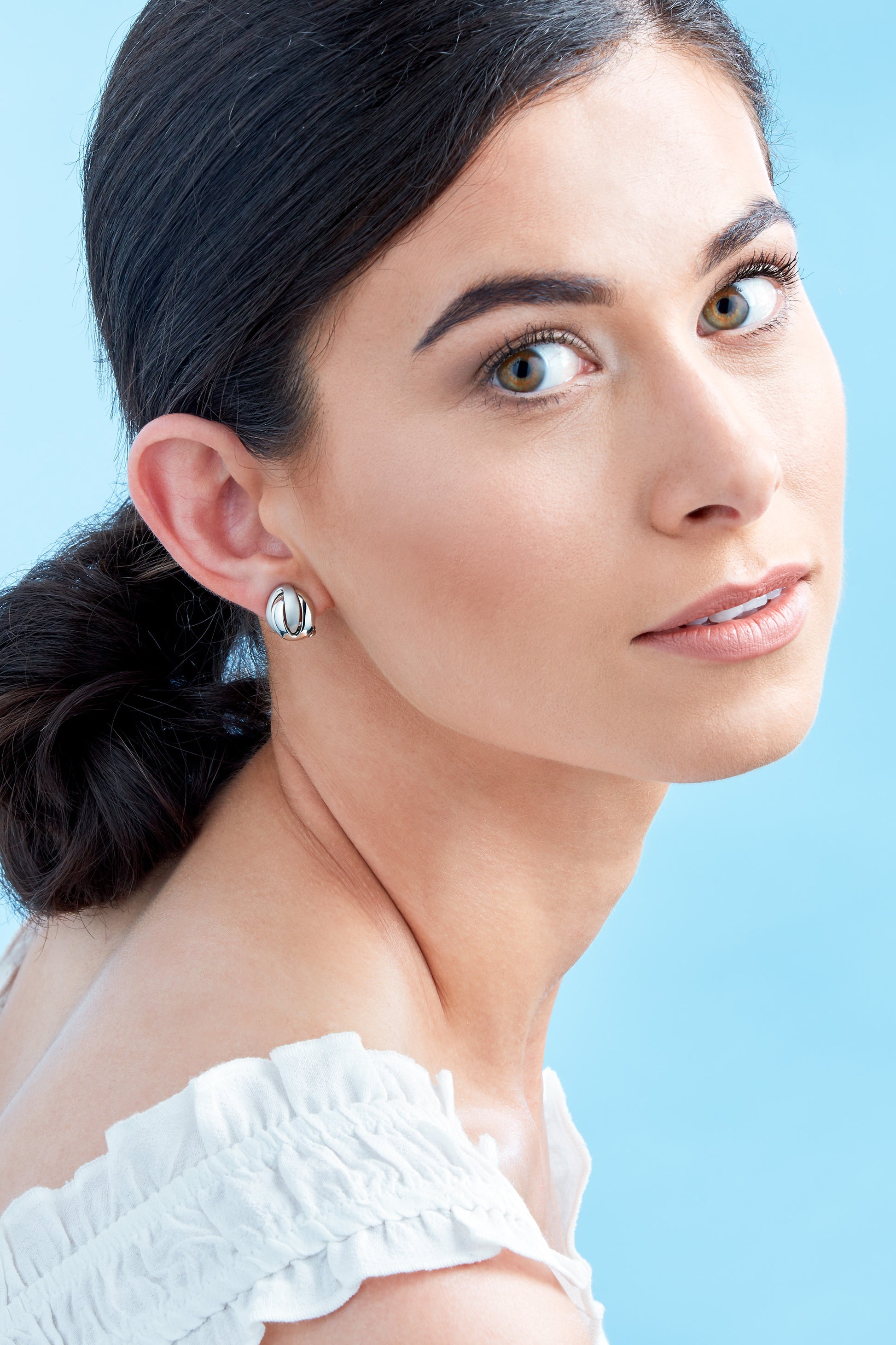 A satin and polished knot design clip on earrings