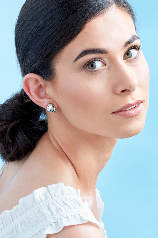 A satin and polished knot design clip on earrings