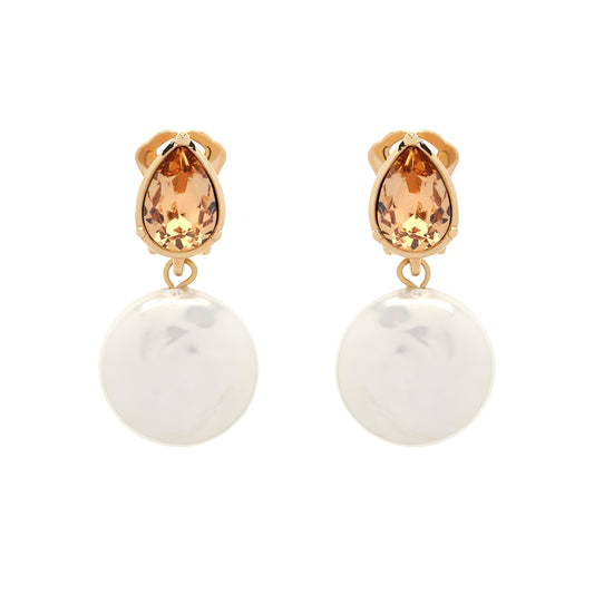 Pair of earrings with teardrop-shaped orange gemstones and round white stones on a white background