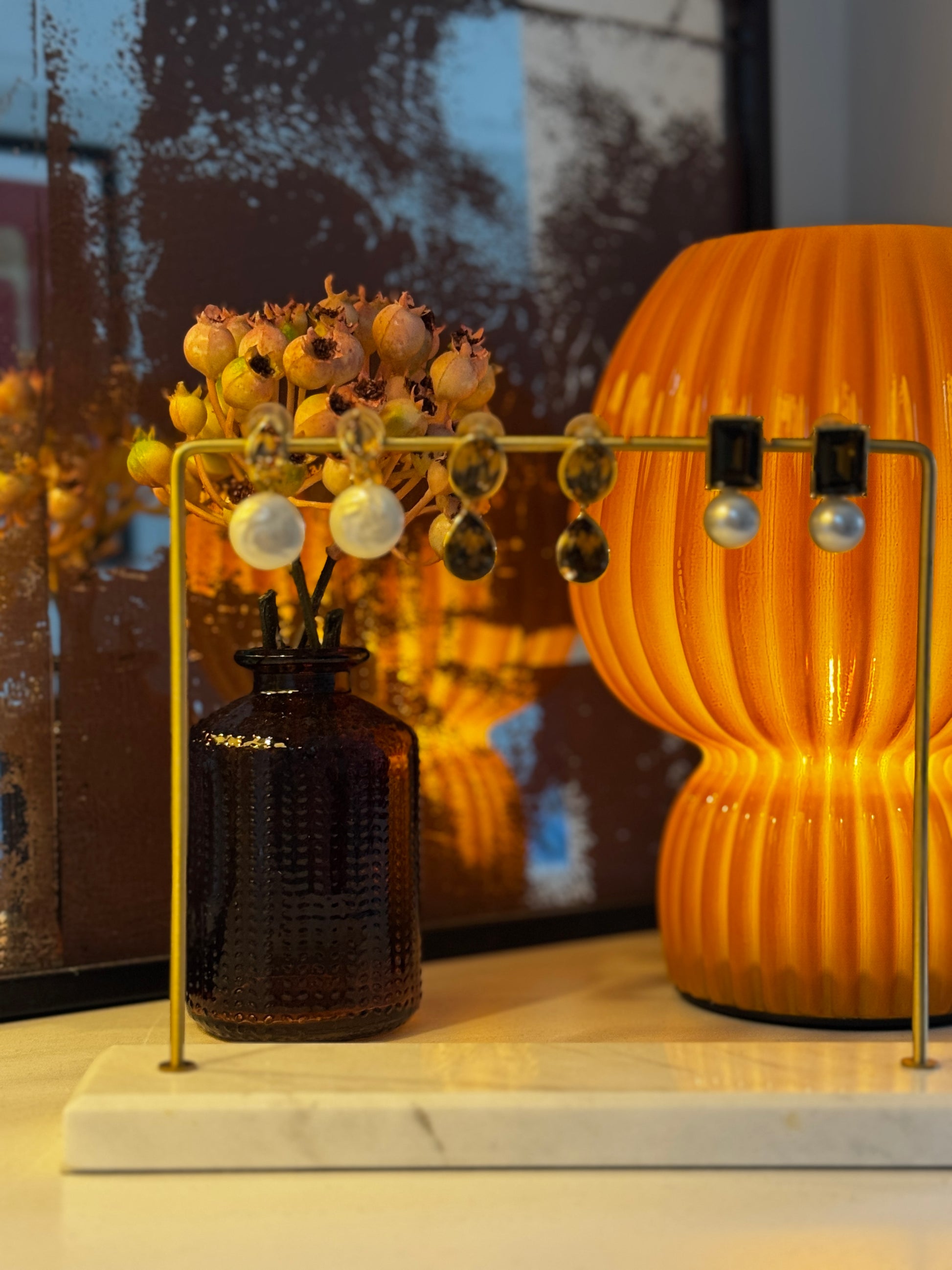 Jewelry display with earrings on stands against a blurred background
