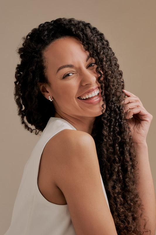 A model wearing Emma Holland crystal trio clip on earrings