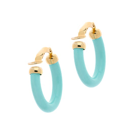 A pair of turquoise resin hoop clip earrings with gold accents and a silicone back.